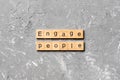 ENGAGE PEOPLE word written on wood block. ENGAGE PEOPLE text on cement table for your desing, concept