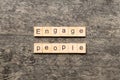 ENGAGE PEOPLE word written on wood block. ENGAGE PEOPLE text on cement table for your desing, concept