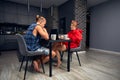 Engaged couple has breakfast together in their new home - young couple smiling while drinking and eating in the kitchen. Royalty Free Stock Photo