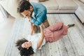 Engaged couple has fun playing with pillows at home Royalty Free Stock Photo