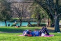 Engaged couple are relaxing on the green lawn