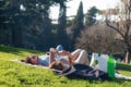 Engaged couple are relaxing on the green lawn