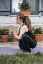 Woman in restorative yoga squat pose