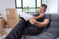 Engaged worker reviews documents on the phone while sitting in a modern office space Royalty Free Stock Photo
