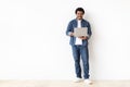 Engaged young black man holding laptop with pleasant smile Royalty Free Stock Photo