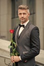 engagement concept. elegant tuxedo man celebrating engagement. man with rose gift for engagement