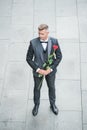 engagement date. grizzle tuxedo man celebrates engagement. man with rose gift for engagement
