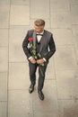 engagement date. handsome tuxedo man celebrates engagement. man with rose gift for engagement