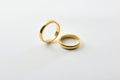 Engagement gold rings standing and lying down isolated over white