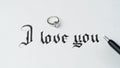 Engagement, love letter with ring, inscription I love you calligraphy