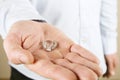 Engagement / marriage / wedding proposal scene. Close up of man handing the expensive gold platinum diamond ring to his bride. Royalty Free Stock Photo