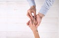 Engagement / marriage / wedding proposal scene. Close up of man handing the expensive gold platinum diamond ring to his bride. Royalty Free Stock Photo