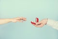 Engagement / marriage / wedding proposal scene. Close up of man handing the expensive gold platinum diamond ring to his bride. Royalty Free Stock Photo