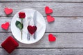 Engagement proposal background, cutlery, rose and glass heart on plate