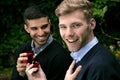 Engagement proposal betwen two gay men as one man proposes with an engagement ring in red box Royalty Free Stock Photo