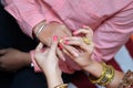 Bride putting engagement ring in groom`s finger. Royalty Free Stock Photo