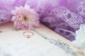 Engagement ring. Retro background with old book and chrysanthemums