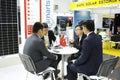 Engaging in dialogue. Asian businessmen sitting at the table at the stand zone and negotiating