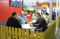 Engaging in dialogue. Businessmen sitting at the table at the stand zone and negotiating. Kiev, Ukraine