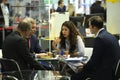 Engaging in dialogue. Female manager talking to businessmen sitting at the table