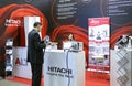 Engaging in partnership. Managers demonstration stand Hitachi, Leica