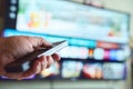 Engaging with a smart TV using a remote Royalty Free Stock Photo