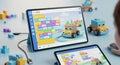 Engaging tablet screen displays colorful block based coding interface with a robotic toy car on display Royalty Free Stock Photo