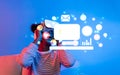 Engaging Young Person Using Virtual Reality Headset for Online Interaction and Advertisement with Digital Icons and Royalty Free Stock Photo