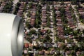 Engine of airplane flying of rooftops of big city Royalty Free Stock Photo