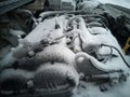 Engine close-up. The engine compartment is covered with snow and ice after a long stay Royalty Free Stock Photo