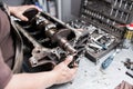 Engine crankshaft, valve cover, pistons. mechanic repairman at automobile car engine maintenance repair work Royalty Free Stock Photo