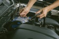Engine engineer is replacing car battery because car battery is depleted. concept car maintenance And the cost of car care.