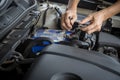 Engine engineer is replacing car battery because car battery is depleted. concept car maintenance And the cost of car care.