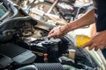 Engine engineer is replacing car battery because car battery is depleted. Royalty Free Stock Photo