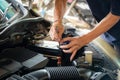 Engine engineer is replacing car battery because car battery is depleted.