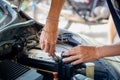 Engine engineer is replacing car battery because car battery is depleted.