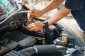 Engine engineer is replacing car battery because car battery is depleted. Royalty Free Stock Photo
