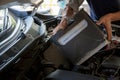 Engine engineer is replacing car battery because car battery is depleted Royalty Free Stock Photo