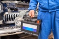 Engine engineer is replacing car battery because car battery is depleted. concept car maintenance. Against the