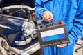 Engine engineer is replacing car battery because car battery is depleted. concept car maintenance. Against the