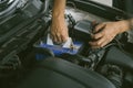 Engine engineer is replacing car battery because car battery is depleted. concept car maintenance And the cost of car care.