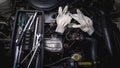Engine repair old cars. Gloves. Tools.