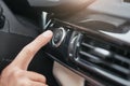 Engine starting. Cropped image of a hand pushing on the start and stop button of car motor. Royalty Free Stock Photo