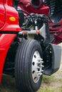 Engine and wheel of red big rig semi truck with open hood Royalty Free Stock Photo