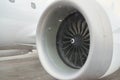 Engine of white passenger airplane at airport during snow blizzard. Royalty Free Stock Photo