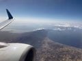 The engine, the wing of the plane and an incredibly beautiful view of the sea and the city from the illuminator. Tourism and Royalty Free Stock Photo