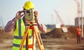 Engineer adjusting theodolite to take accurate measurements