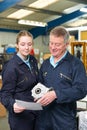 Engineer And Apprentice Looking At Component In Factory Royalty Free Stock Photo