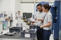 Engineer And Apprentice Meet On Floor Of Engineering Workshop Royalty Free Stock Photo