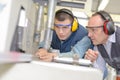 Engineer and apprentice using automated milling machine Royalty Free Stock Photo